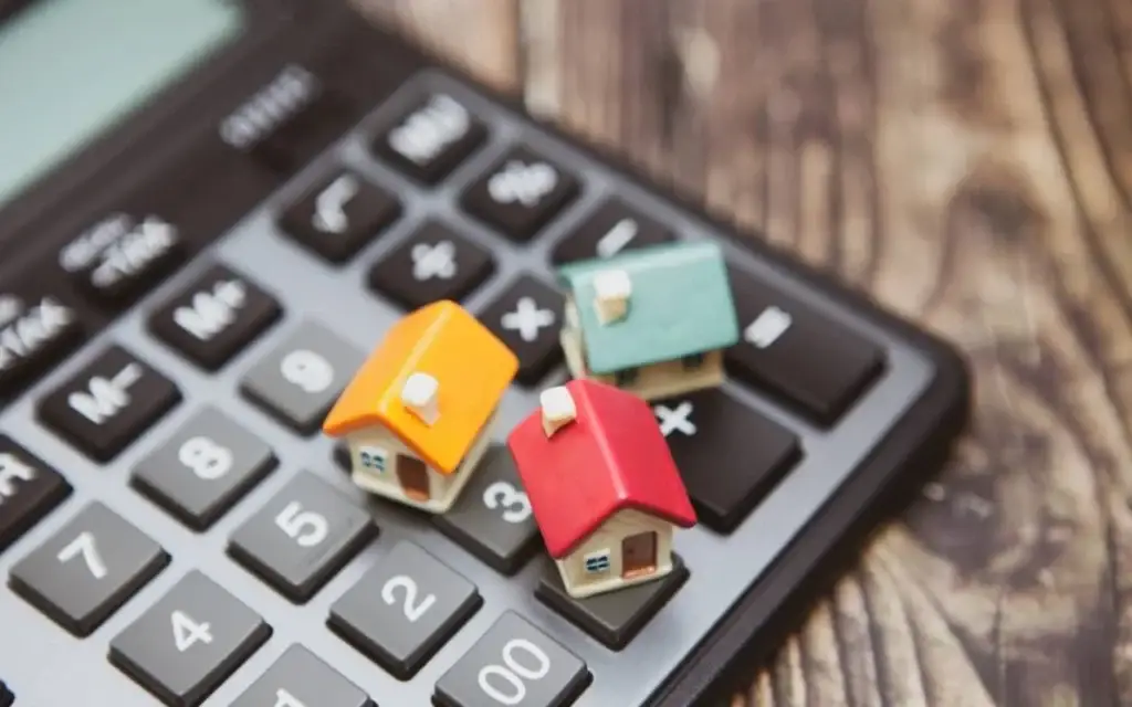 three tiny house toys placed on laptop