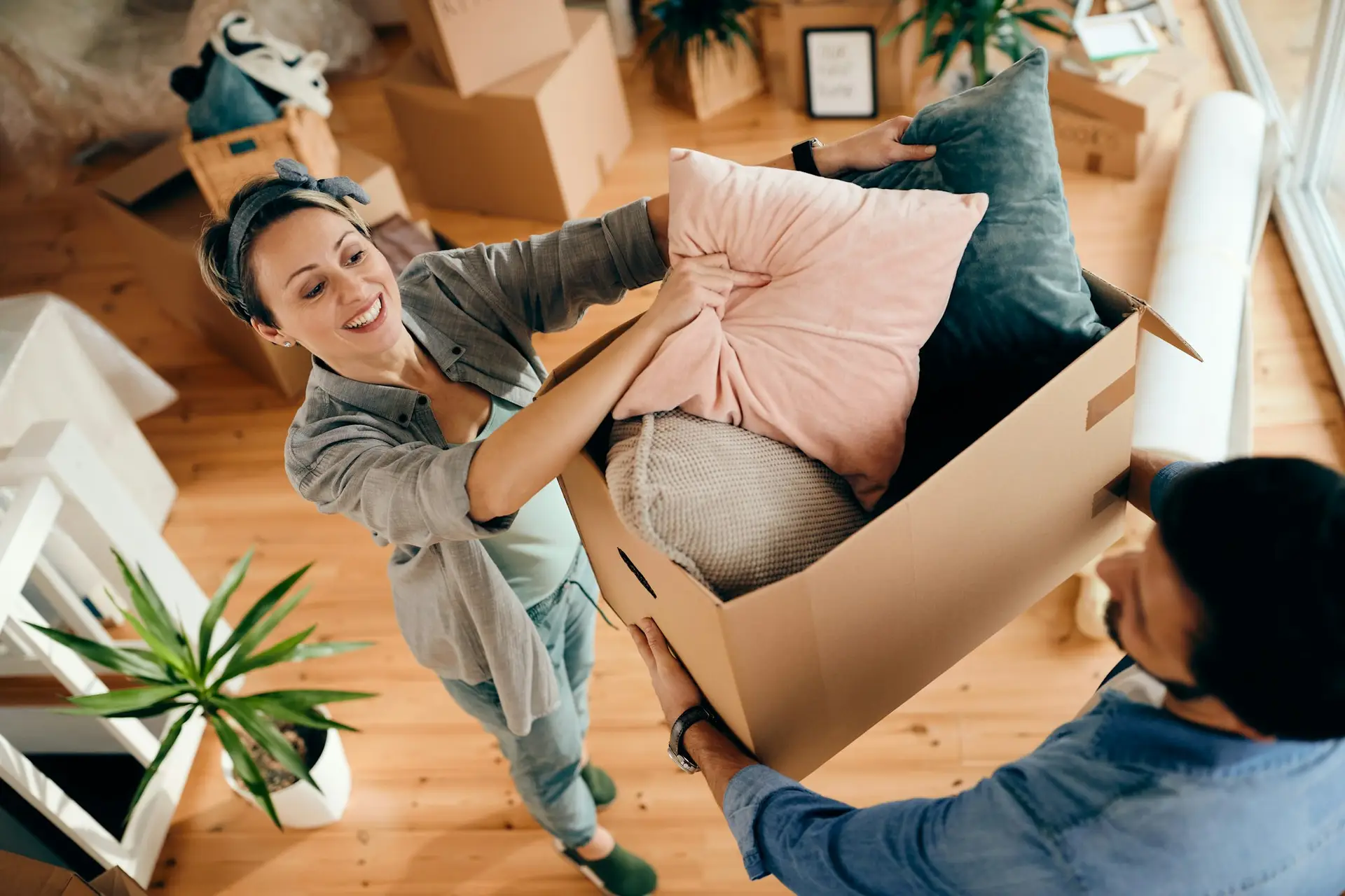 View of happy couple moving into their new home thanks to their best rate moving mortgage