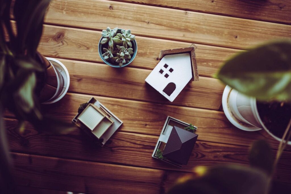 Image of a house and plants for securing the best mortgage IMC blog post